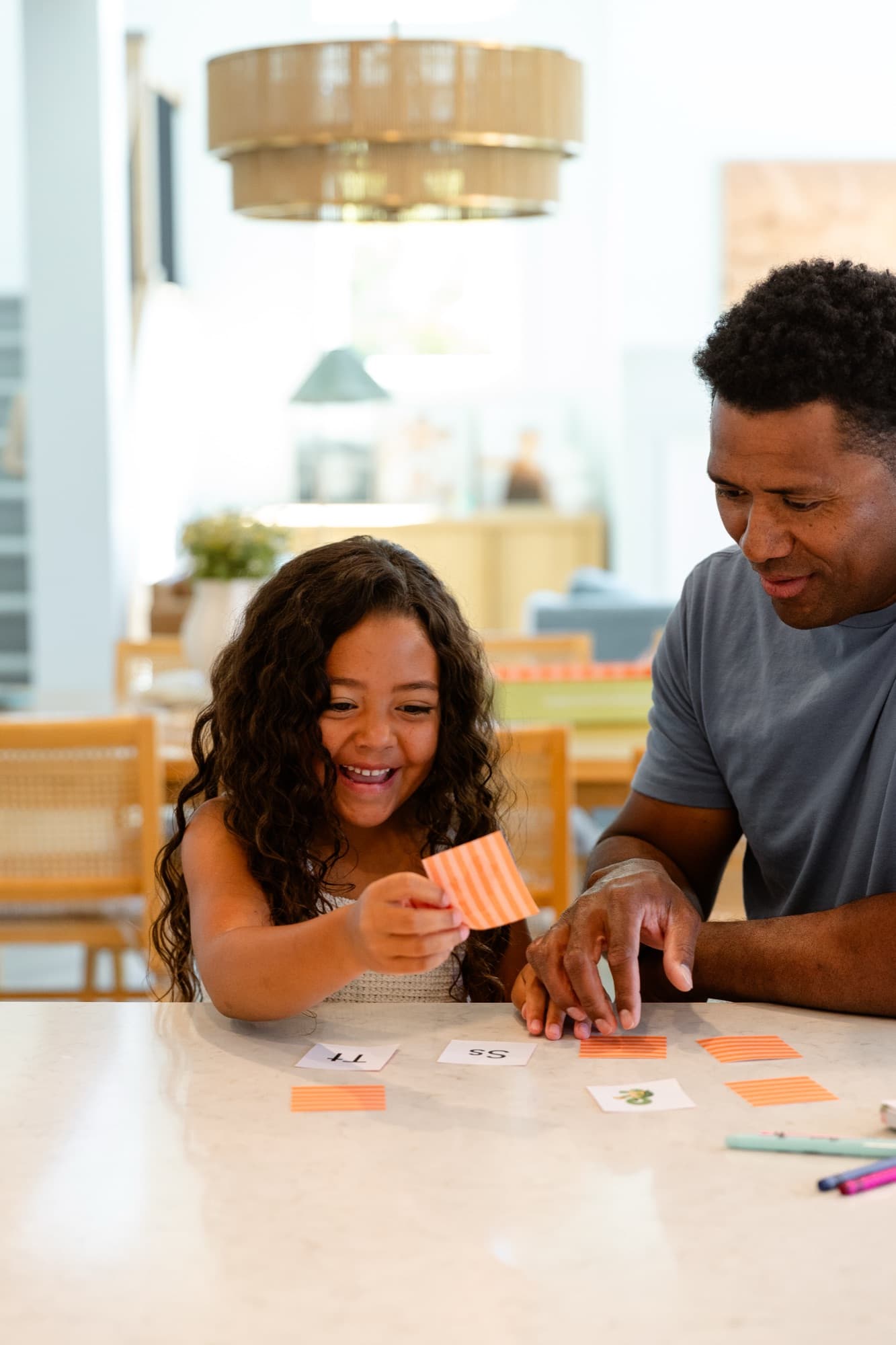 A dad and daughter playing a letter matching game