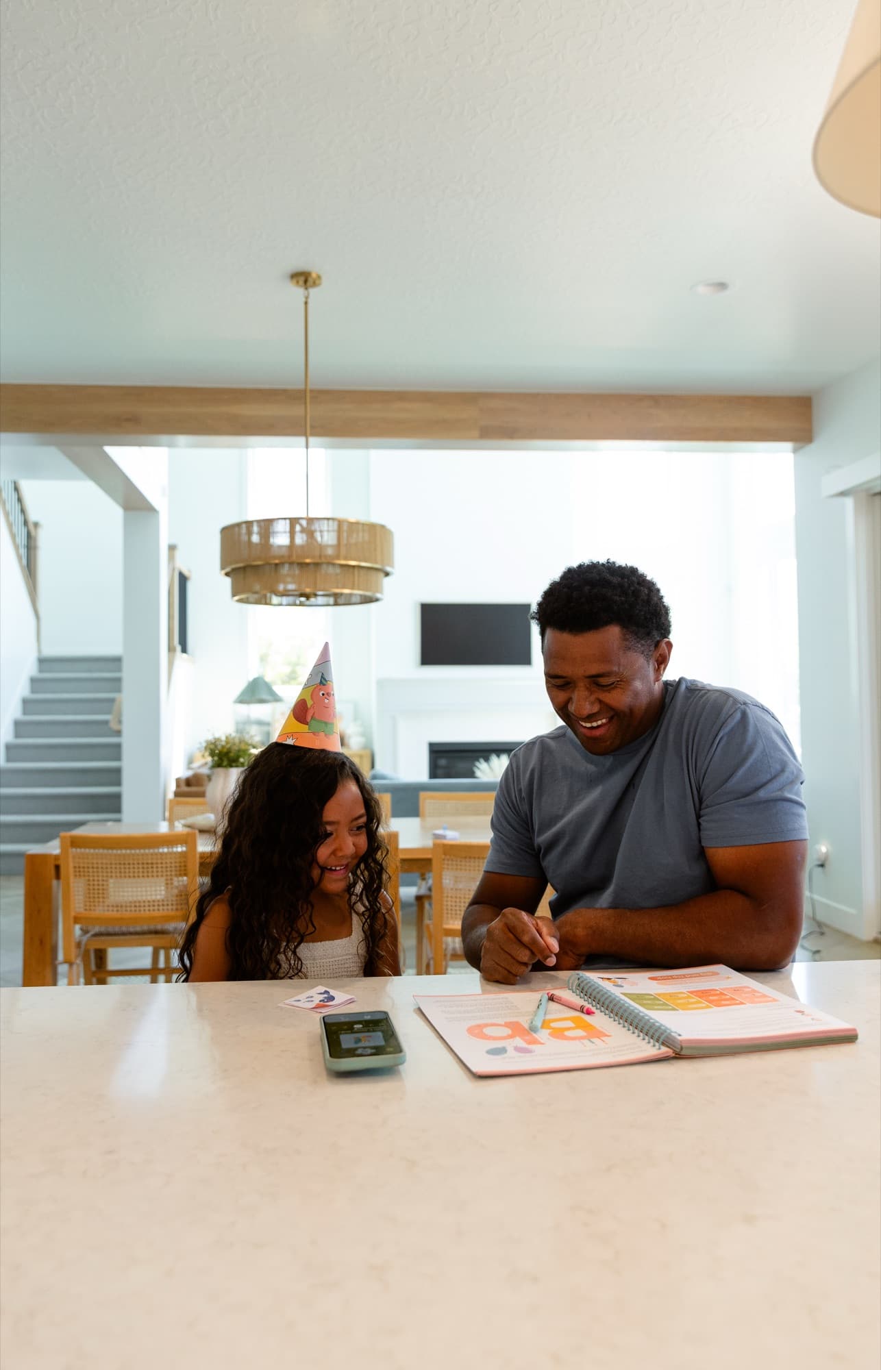 A dad and daughter celebrating a lesson at the kitchen counter