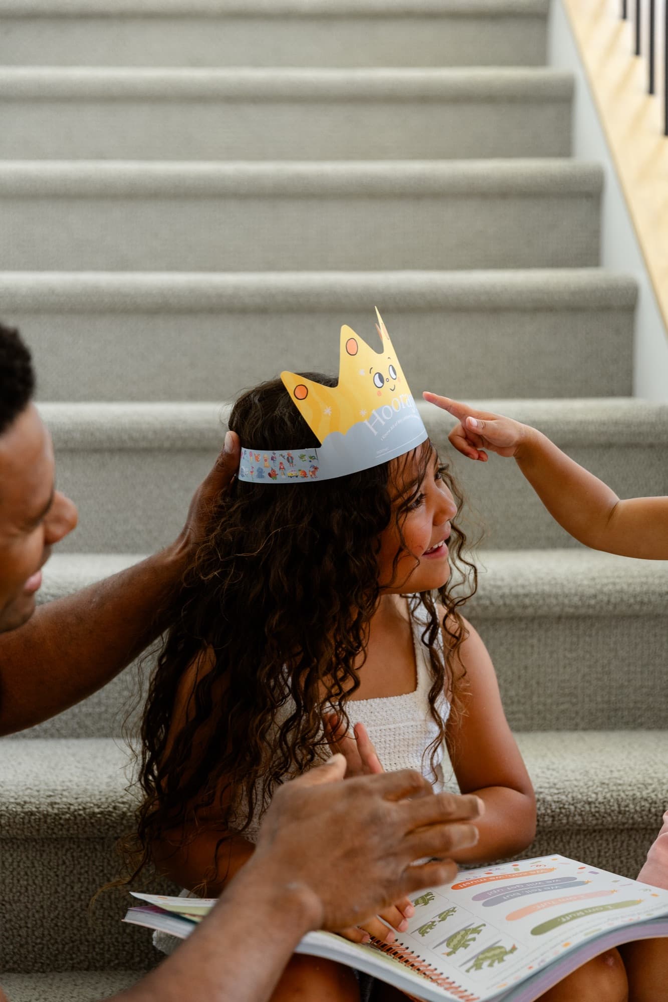 A dad crowning his daughter with the Hooray crown